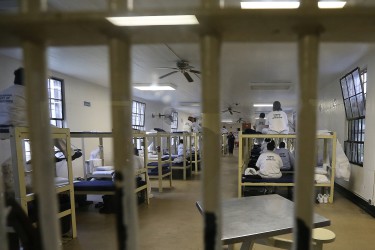 Inmates sit on their bunks in an overcrowded dormitory at Tutwiler Prison for Women in Wetumpka, Ala., Thursday March 31, 2016, as Gov. Robert Bentley, other officials and the media tour the facility. The prison, like every state prison, is overcrowded, with 945 inmates in a facility designed to hold 545. Gov. Robert Bentley is proposing issuing an $800 million bond to build four new facilities, one women's prison and three men's facilities, which would reduce replicated services, save money for the department and provide more space for training and rehabilitative services. (Governor's Office, Jamie Martin)