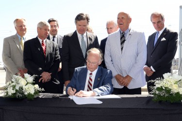 Governor Robert Bentley, joined by state and local officials, signs the Alabama Renewal Act at the Port of Mobile, Friday, April 8, 2016. (Governor's Office, Jamie Martin)