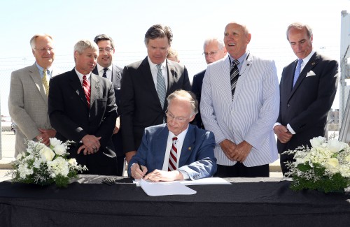 Governor Robert Bentley, joined by state and local officials, signs the Alabama Renewal Act at the Port of Mobile, Friday, April 8, 2016. (Governor's Office, Jamie Martin)