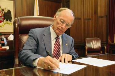 Alabama Governor Robert Bentley signs Executive Order 20 authorizing Alabama county children’s policy councils to work with local Child Advocacy Centers to develop child sexual abuse prevention plans in his office at the State Capitol on Thursday, April 28, 2016. (Governor's Office, Daniel Sparkman)