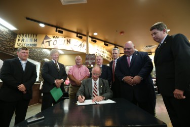 Alabama Gov. Robert Bentley signs an Executive Order creating the Alabama Disaster Recovery and Resiliency Task Force at the Hackleburg Market & Cafe joined by state and local officials on Wednesday, April 27, 2016, the five year anniversary of the devastating tornadoes that tore a path through Alabama, killing 254 people, and almost leveling the town of Hackleburg. The task force will make recommendations to the Governor regarding strategic, long-term reforms and find ways to enhance the efficient and cost-effective delivery of emergency management services in Alabama. (GovernorÕs Office, Jamie Martin)