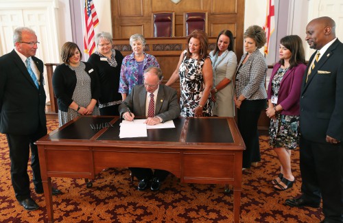 Alabama Governor Robert Bentley signs HB238, Erin's Law, sponsored by state Representative Terri Collins during a ceremonial bill signing in the Old House Chamber at the State Capitol in Montgomery on Tuesday, May 17, 2016. Joining Governor Bentley and Rep. Collins for the signing were members of the Governor’s Task Force on Prevention of Sexual Abuse of Children which suggested the legislation. (Governor's Office, Daniel Sparkman)