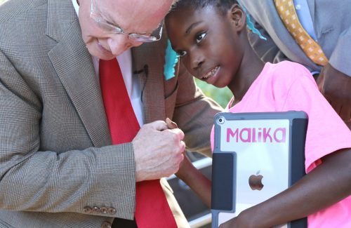 Alabama Governor Robert Bentley embraces young Malika Shoulders, a non-verbal student attending J.E. Hobbs Elementary School in Camden, Ala. Malika will be able to communicate better with her new iPad, one of hundreds donated as part of a $900,000 Apple grant made available through the White House ConnectED initiative to J.E. Hobbs Elementary School In Camden, Ala., which Gov. Bentley announced today Tuesday, Oct. 18, 2016 at the school. As part of the grant, every student will receive an iPad, each teacher and administrator will receive a MacBook and iPad Mini along with an Apple TV for every classroom. Teachers will receive training and have been assigned a team of Apple specialists to provide ongoing professional development and support to incorporate the technology into their curriculum. (Governor's Office, Jamie Martin)